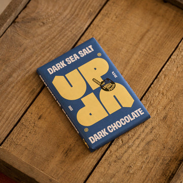 Dark Sea Salt Uppercut Dark Chocolate bar on a wooden surface